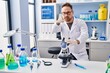 © Krakenimages.com - Middle age caucasian man working at scientist laboratory pointing with finger to the camera and to you, confident gesture looking serious