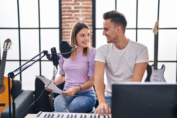 Poster - Man and woman musicians singing song playing piano at music studio