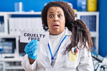 Poster - Plus size hispanic woman working on cruelty free laboratory scared and amazed with open mouth for surprise, disbelief face