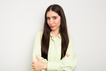 Wall Mural - Young caucasian woman isolated on white background suspicious, uncertain, examining you.