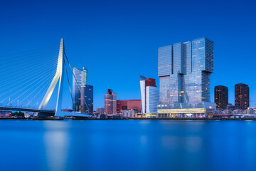 Wall Mural - Rotterdam, Holland. View of the Erasmus Bridge and the city center. Panoramic view. Cityscape in the evening. Skyscrapers and buildings.