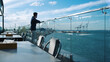 © stockbusters - Millennial guy resting terrace at sea port view. Freelancer enjoying ocean view