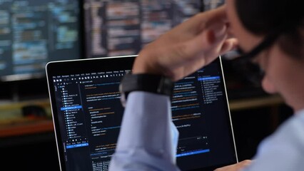 Close Up Of A Laptop'S Monitor Showing Database Being Written By A Male With Multiple Monitors Desktops. Programmer Having A Headache Working In The Office
