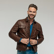 © Viorel Sima - casual man opening his jacket with a smile on his face