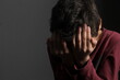 © herlanzer - child praying to God with hands together with black background with people stock photo