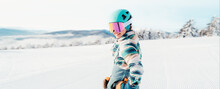 Woman in skiing clothes with helmet and ski googles on her head with ski sticks. Winter weather on the slopes. Mountain and enjoying view. Alpine skier. Winter sport. Ski touring