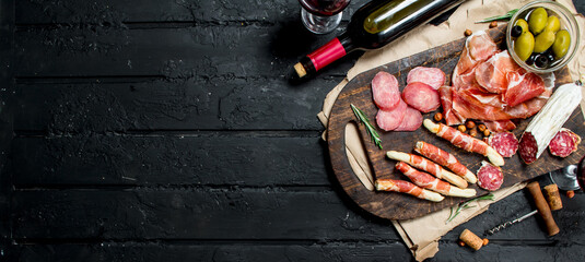 Antipasto background.Traditional Italian appetizers with red wine.