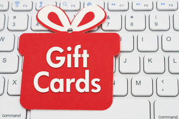 Wall Mural - Gift Cards message on red gift tag on a keyboard