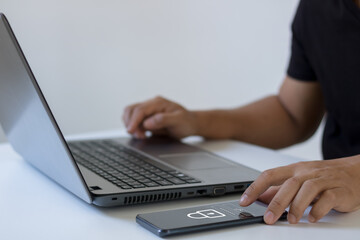 Cyber security concept. Business people type passwords and press the check button on a mobile smartphone application connect to the database via a data security system technology on display at office