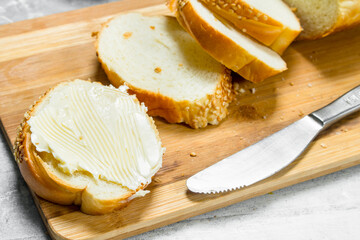 Poster - Breakfast. Fresh bread and butter on a wooden Board.