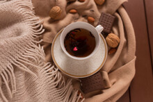Tea Cup With Heart Shaped Sugar Lying On Caramel Fabric And Coco