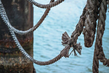 Knot On An Old Ship Rope On A Jetty Over The Water, Metaphor For Cohesion, Copy Space, Selected Focus