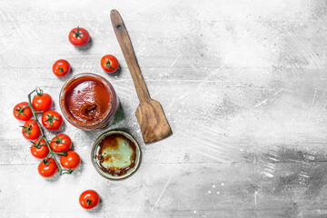 Poster - Tomato sauce in a glass jar with a scoop.