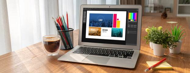 Graphic designer software for modern design of web page and commercial ads showing on the computer screen