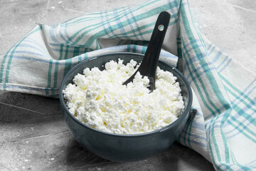 Cottage cheese in a bowl with a spoon.