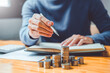 © joyfotoliakid - Saving money concept Man hand putting Row and coin Write Finance Saving money concept Man hand putting Row and coin Write Finance