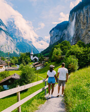 Lauterbrunnen Valley,village Lauterbrunnen, Staubbach Fall, And Lauterbrunnen Wall In The Swiss Alps, Switzerland. Europe Lauterbrunnen Valley, A Couple Of Caucasian Men And Asian Women On Vacation