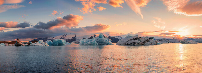 Wall Mural - Scenery of Jokulsarlon glacier lagoon with blue iceberg melting and sunset sky on summer