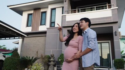 Wall Mural - happy family standing outside their house, husband talking with pregnant wife