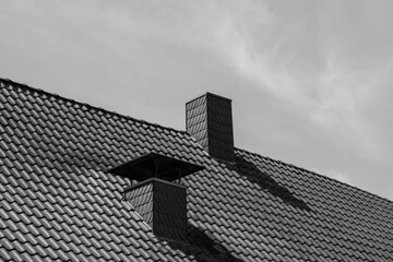 grayscale shot of chimney on the roof