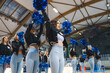 Low-angle shot of a cheerladers squad presenting a choreography. Sport concept. High quality photo