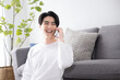 Asian male making a phone call Copy space available Smiling　
