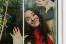 Smiling Woman Making Faces Seen Thorough Glass
