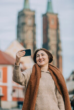 Happy Mature Woman Taking Selfie Through Smart Phone