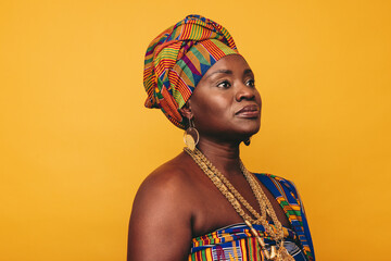 Mature African woman wearing traditional clothing in a studio