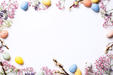 Wall Mural - Beautiful Easter composition with spring flowers and colorful quail eggs over white background. Springtime and Easter holiday concept with copy space. Top view