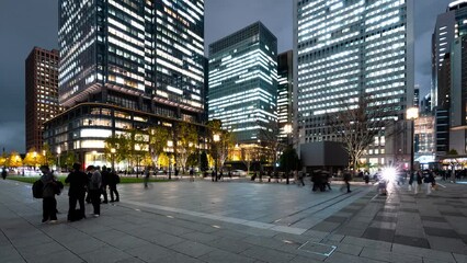 Wall Mural - Night time lapse of crowded people walk, car traffic transportation at Marunouchi financial business district in Tokyo. Japanese job work lifestyle, Japan economy, Asia transport or Asian city life