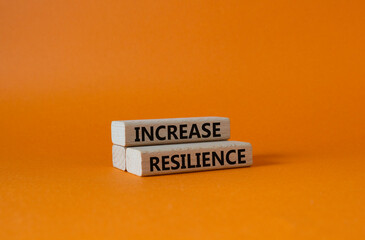 Increase resilience symbol. Wooden blocks with words Increase resilience. Beautiful orange background. Business and Increase resilience concept. Copy space.
