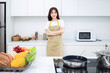© Timeimage - Image of young Asian woman in the kitchen