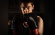 © Cavan Images - Portarit of young boxer on guard during training in gym.