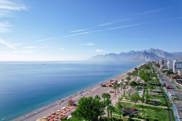 Wall Mural - Aerial view of beautiful blue gulf and Konyaalti beach in popular resort city Antalya, Turkey.