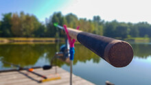 Fishing Rod On The Background Of A Pier On The Banks Of A River Or Lake. Foggy Morning. Wild Nature. The Concept Of Recreation In The Countryside. An Article About A Day Of Fishing.