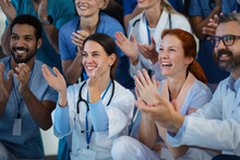 Portrait Of Happy Doctors, Nurses And Other Medical Staff Clapping In Hospital.