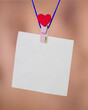 Heart clothes peg holding note