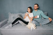 © GVS - Happy smiling couple drinking coffee relaxing on couch
