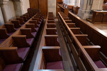 Wall Mural - Empty wooden pews or chairs inside Gothic, medieval church in Europe. Wide angle, no people