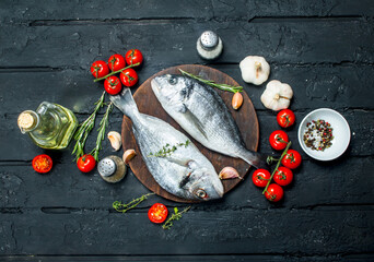 Sticker - Raw sea fish dorado with seasonings and tomatoes.