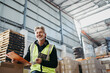 © Jacob Lund - Happy senior man working in a distribution warehouse