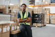 © Jacob Lund - Logistics worker looking at the camera in a distribution warehouse