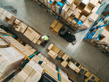 Top View Of A Warehouse Employee Moving Goods In A Logistics Centre