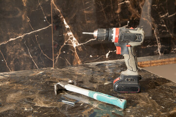 Poster - Cordless screwdriver at home. Construction tool