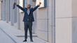 © Yuliia - Overjoyed happy success African American man worker manager intern businessman winner walk outdoors feel overjoyed excited jumping dancing celebrating professional triumph victory corporate reward