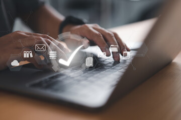 Leinwandbilder - A businessman is using a laptop with a virtual document and a correct sign for online approval of the paperless and quality assurance concept.