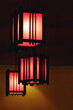 © fotosenukas - Rectangular red lamps in a restaurant on a dark background