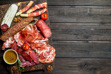 Antipasto background. Assortment of meat snacks on the Board .