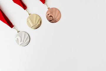 Gold, silver and bronze medals with numbers on white isolated background for winners. Medal with red ribbons.Winter games , useful for banner,background